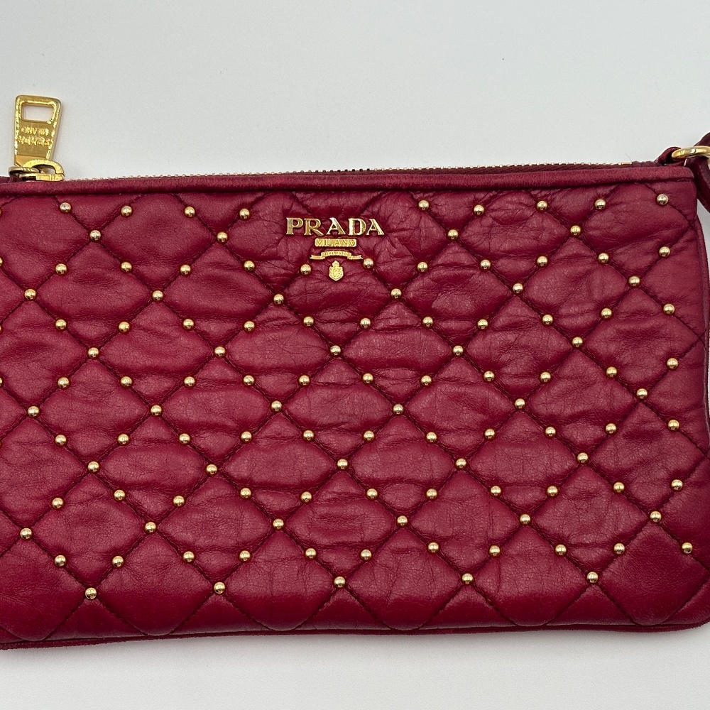 Red Prada leather pouch with gold studs